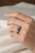 14k black gold engagement ring with three blue diamonds totaling 1.0 carats, showcasing elegant jewelry design and sparkle.