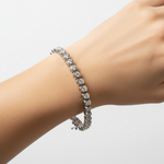 14k solid gold diamond bezel tennis bracelet with 1.96 carats total weight, displayed on a model showcasing its elegant design.