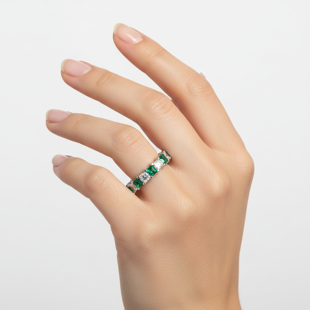 14k gold green emerald and diamond eternity wedding band with 3.57 carats total on a model.