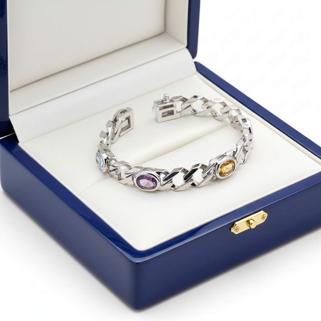 14k white gold multi-colored gemstone bracelet with oval-cut stones, displayed in a royal blue wooden box.