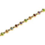 Gold bracelet with hexagonal gemstones on a white background
