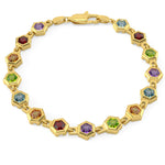Gold bracelet with colorful gemstones on a white background