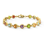 Gold bracelet with heart-shaped gemstones on a white background