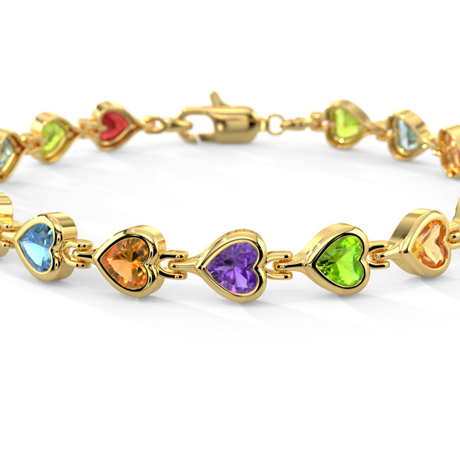 Gold bracelet with heart-shaped gemstones on a white background