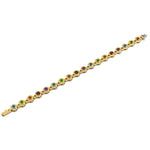 Gold bracelet with multicolored gemstones on a white background