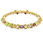 Gold bracelet with colorful gemstones on a white background