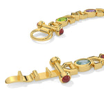Gold bracelet with gemstones on a white background