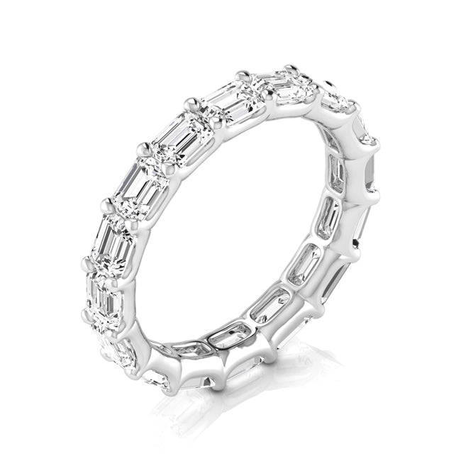 A white gold eternity ring featuring baguette-cut clear gemstones, shown on a clean white background with a soft reflection.