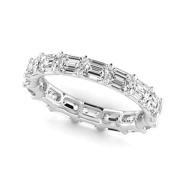 Diamond ring with emerald-cut iamonds on a white background