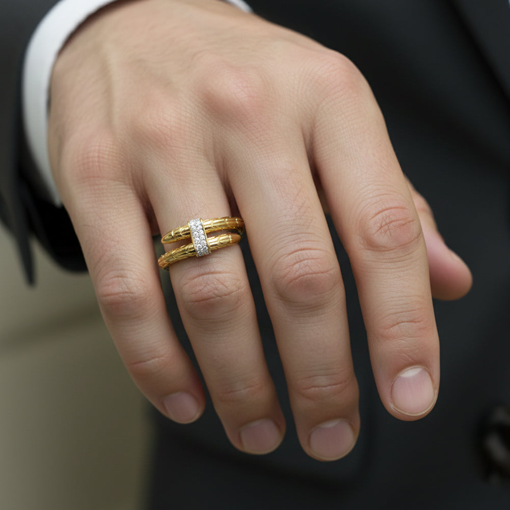 Hand wearing a gold ring with a diamond on a blurred background