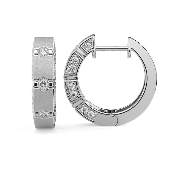 Gold hoop earrings with embedded diamonds on a white background