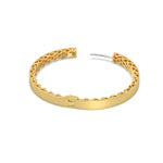Gold hoop earring with intricate design on a white background