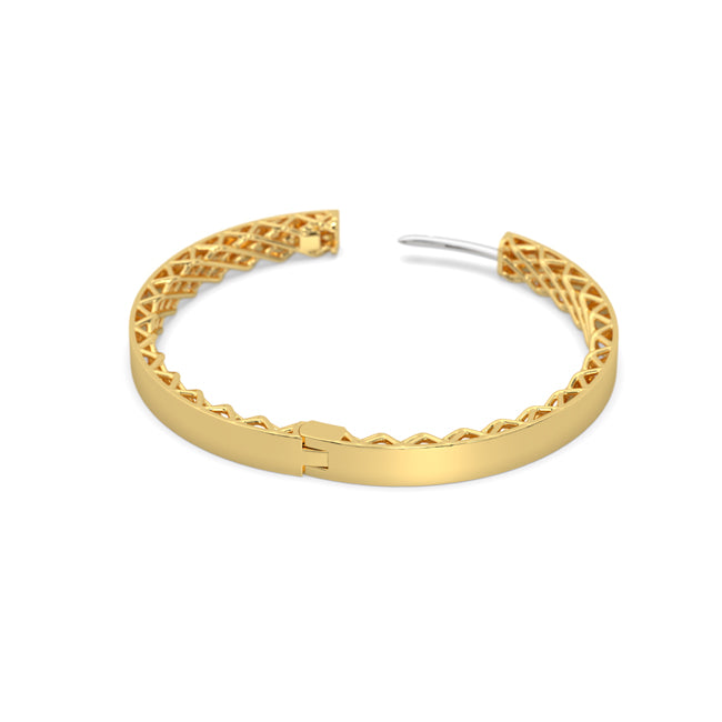 Gold hoop earring with intricate design on a white background