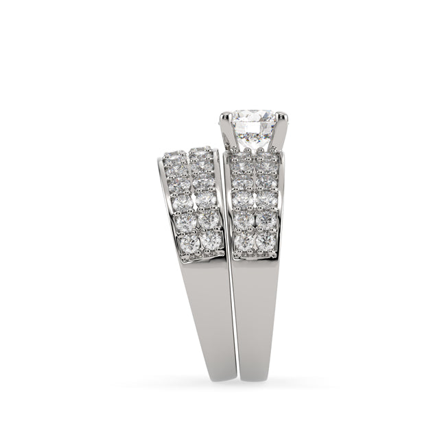 Pair of diamond-studded bridal set rings on white background
