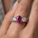 14K white gold oval ruby and diamond fashion ring with 1.50 carats total weight, featuring a sparkling gemstone design.