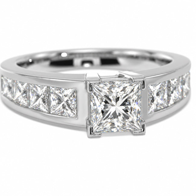 A white-toned diamond ring featuring a large princess-cut center stone with channel-set diamonds on either side, shown on a clean white background.