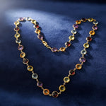 Multicolored gemstone necklace on a dark blue background