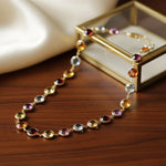 Necklace with multicolored gemstones on a wooden surface