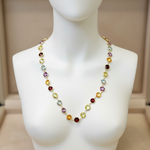 Multicolored beaded necklace on a mannequin against a neutral background