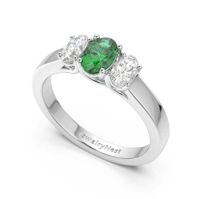 Silver ring with a green gemstone and two diamonds on a white background, branded 'JewelryNest'.