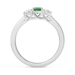 Silver ring with a green gemstone and diamond accents on a white background