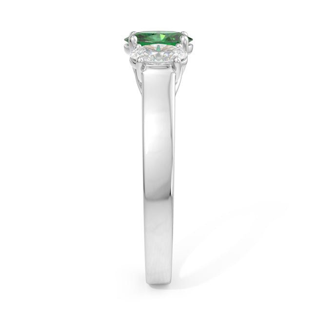 Silver ring with a green gemstone on a white background