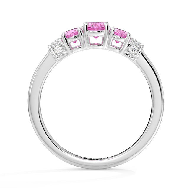 Silver ring with pink gemstones on a white background