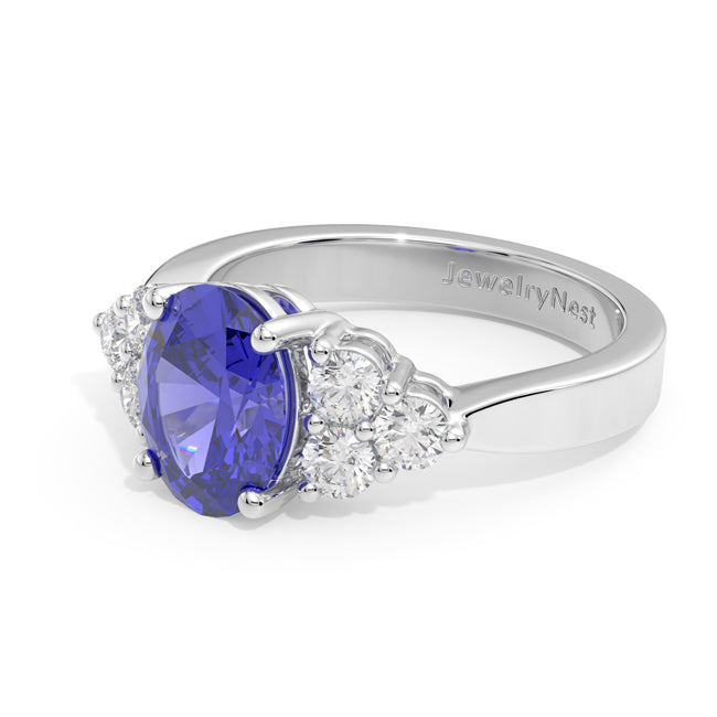 Gold ring with a blue gemstone and diamonds on a white backgroundld
