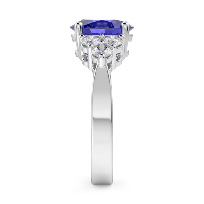 Gold ring with a blue gemstone and clear stones on a white background