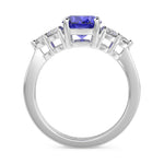 Gold ring with a purple gemstone and diamond accents on a white background