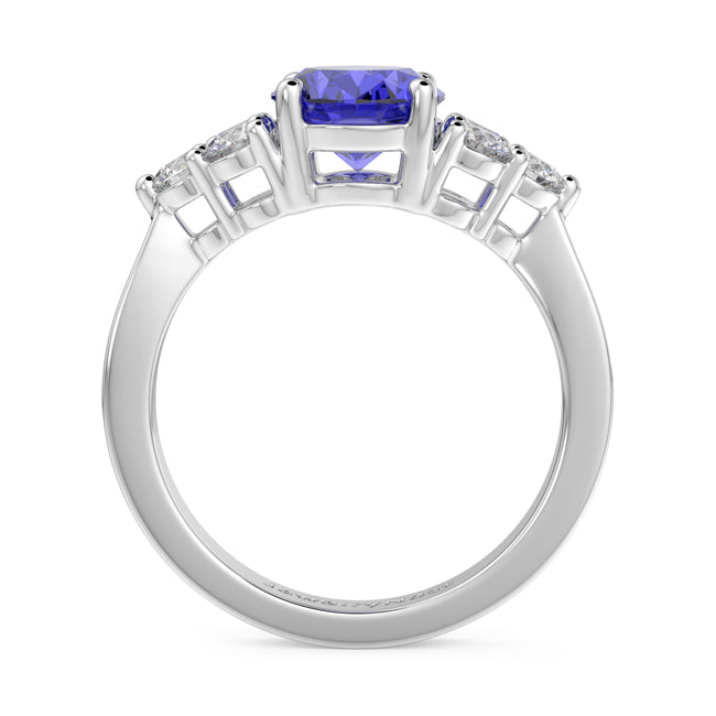 Gold ring with a purple gemstone and diamond accents on a white background