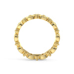 A yellow gold eternity ring featuring a continuous channel setting of small round-cut diamonds, shown from a top-down perspective on a clean white background.