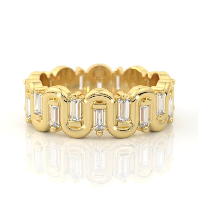 A yellow gold eternity-style ring featuring baguette and round-cut clear stones, shown on a clean white background with a soft reflection below.