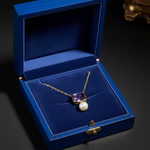 14k gold octagon amethyst and freshwater pearl pendant necklace displayed in a royal blue jewelry box.