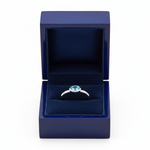 14k gold oval blue-topaz solitaire fashion ring with 0.50 ct tw, displayed in a royal blue gift box, by JewelryNest.