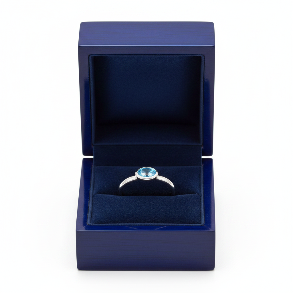 14k gold oval blue-topaz solitaire fashion ring with 0.50 ct tw, displayed in a royal blue gift box, by JewelryNest.