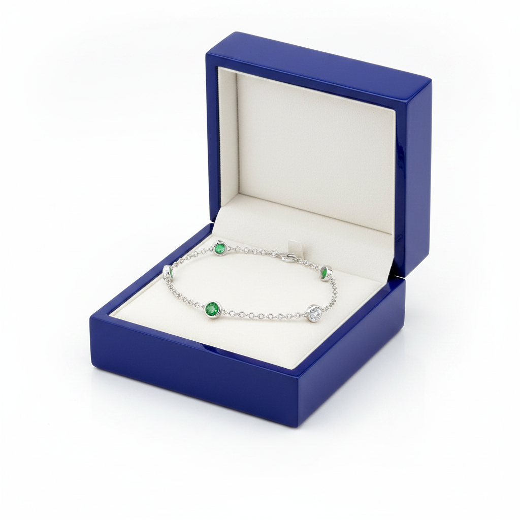 Diamond emerald station bracelet on royal blue wooden box