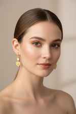 Heart cherub diamond earrings on model