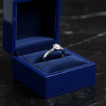 14k white gold round bezel solitaire diamond ring in royal blue wooden jewelry box