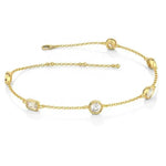 Gold bracelet with diamond-like stones on a white background