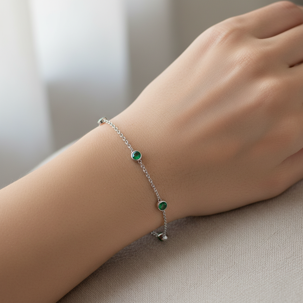 Model wearing diamond emerald station bracelet