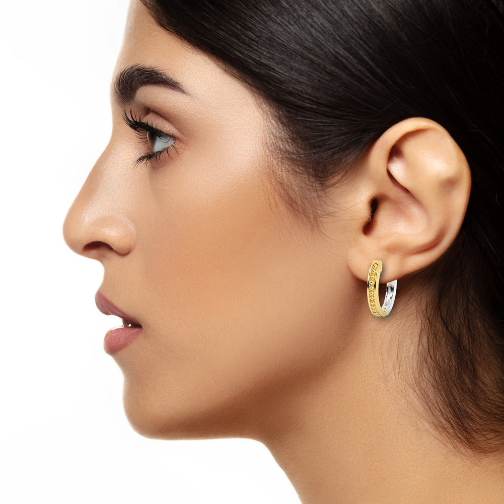 14k Solid Gold Oval Two-Tone Caviar Huggie Earrings On Woman Ear (6.3.gr.tw)