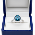 14k white gold solitaire ocean blue diamond ring with 0.90 ct tw, displayed in a royal blue wooden box.
