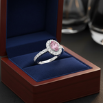 14k gold oval pink sapphire and diamond fashion ring with halo setting, displayed in a gift box.