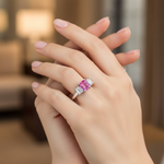 14k gold three stone pink sapphire and diamond ring on a hand, showcasing sparkling pink sapphires and diamonds in a fashion ring design