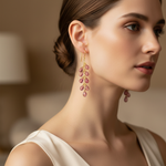 14k gold teardrop pink tourmaline earrings with 13 carats total weight, featuring faceted briolette stones on a model.