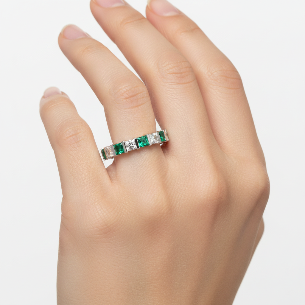 14k gold princess diamond and green emerald eternity wedding band with 2.0 carats total weight, jewelry model displaying the ring.