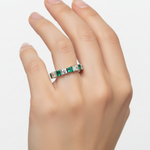14k gold princess diamond and green emerald eternity wedding band with 2.0 carats total weight, jewelry model displaying the ring.