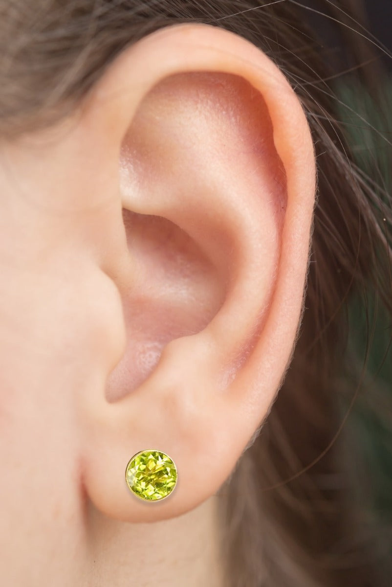 14k Gold Round Peridot Earrings Stud On Woman Ear (0.60.ct.tw)