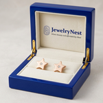 Rose-gold diamond star studs in a royal-blue wooden box with the JewelryNest logo